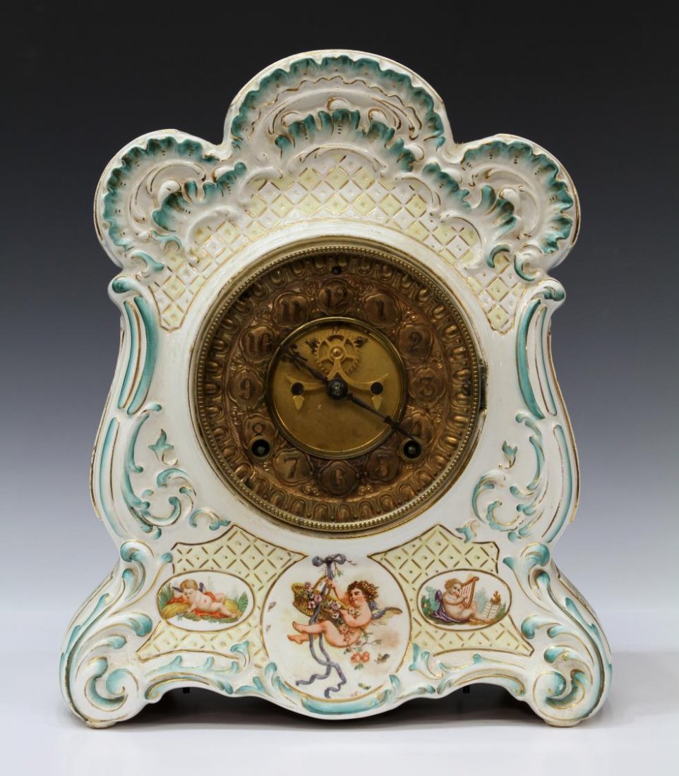 ANSONIA COMPANY PORCELAIN CASE MANTLE CLOCK: Ansonia Clock Co. porcelain mantle clock, late 19th c., Louis XV style case having floral and gilt motif, cherubs decorating front, gilt face with open escapement, door verso to housing time and strik