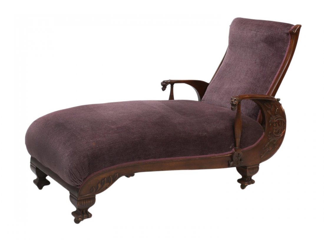 VICTORIAN RECLINING CHAISE LONGUE: Victorian chaise longue, late 19th c., a mahogany frame with applied foliate carving, the shaped arms terminating in griffin heads with ribbed supports while flanking the later purple upholstery, the