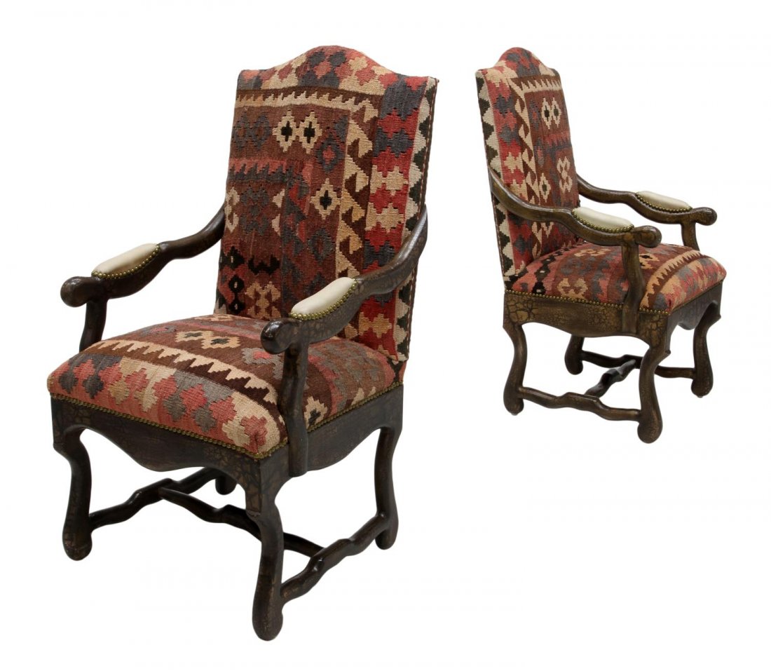 (PAIR) DESIGNER ARM CHAIRS: (pair) Arm chairs with antiqued wood frames, late 20th c., kilim rug upholstery with micro-suede fabric accents, an arched crest back, shaped padded arms with nail head accents, stretcher joined scrol