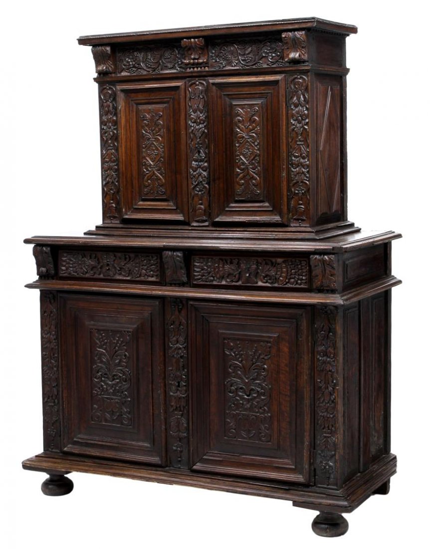 LOUIS XIV PROVINCIAL CHEST ON CUPBOARD, C. 1700: French Louis XIV provincial chest on cupboard, c. 1700, decorated with substantial foliate and floral relief carving, the upper chest cornice over dentil moulding, a carved frieze, two drawers opening