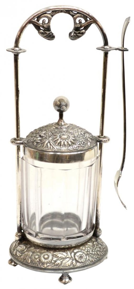 AMERICAN VICTORIAN SILVERPLATE PICKLE CASTOR: American silverplate pickle castor with paneled glass jar and fork, frame marked 'Meriden B Co. Pat July 14 1868', intricate foliage motif on frame with attached lid which slides upwards and rests all