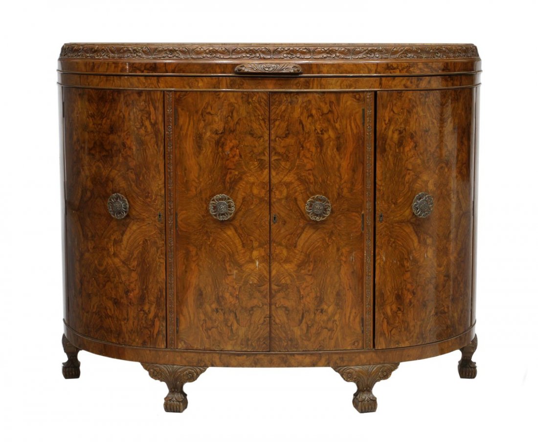 ART DECO BURL WALNUT COCKTAIL CABINET: English burl walnut art deco cocktail bar, 1930's, a demilune form with foliate carved edge top lifting to reveal the maple interior with a mirrored service bar, two central doors opening to stepped b