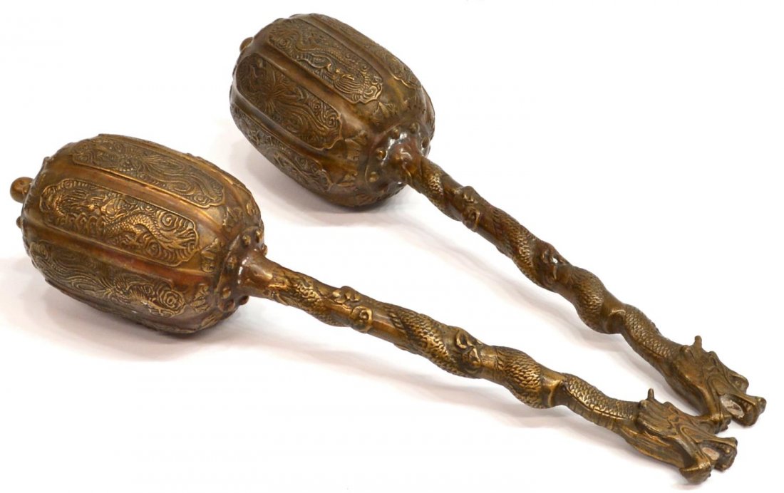 (2) CHINESE BRONZE DRAGON CEREMONIAL MACES: (pair) Chinese bronze ceremonial maces, each of lobed form with bats surmounting dragon and phoenix decorated reserves, the long stem of each intertwined with a full bodied dragon, 17"l, 6.75lbs total