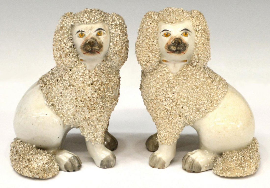 (2) STAFFORDSHIRE FRIT POODLE DOGS: (pair) Staffordshire earthenware Frit poodles, each in a seated pose, crazing with age, approx 5.5"h, 4"w, 3"d, 1.75lbs total Start Price: $200.00