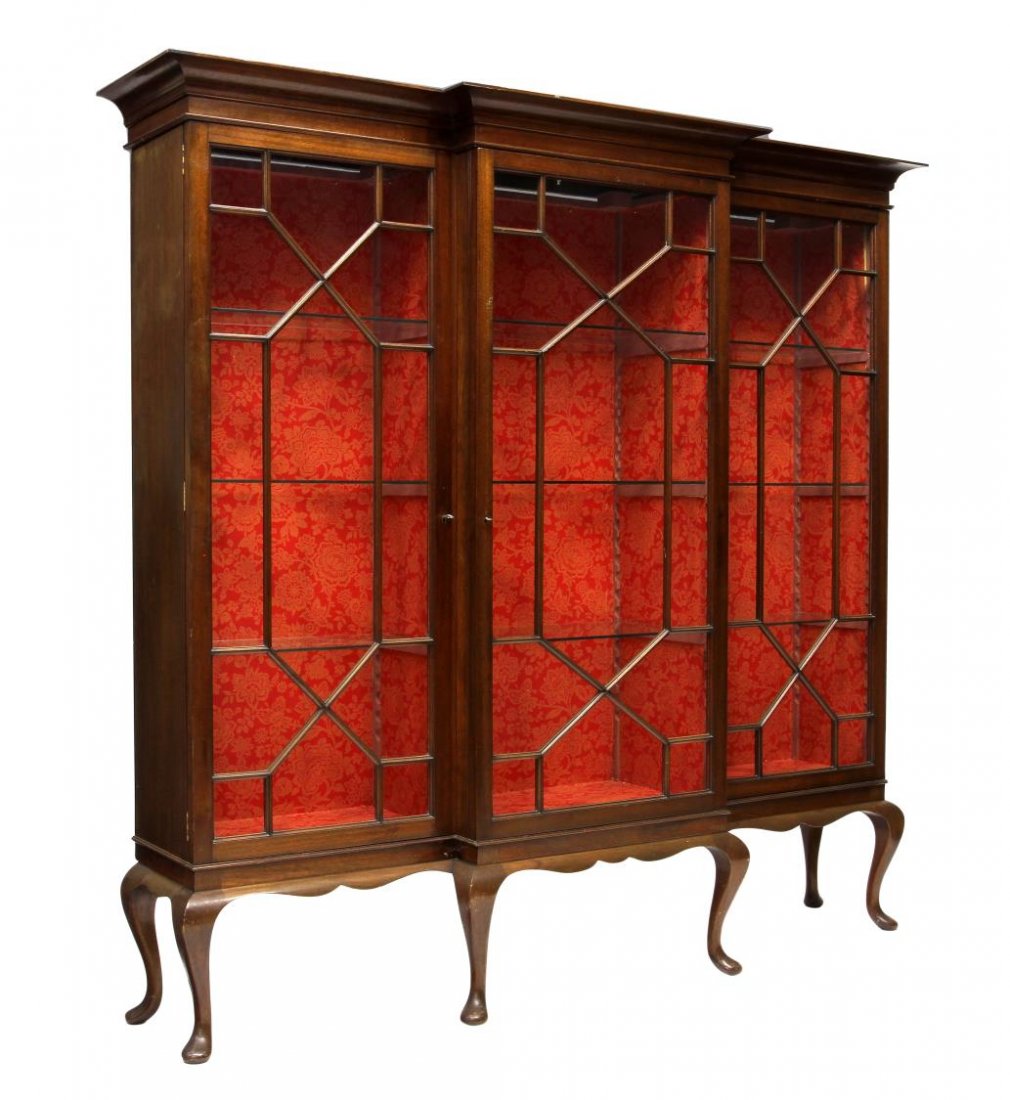 LARGE ENGLISH MAHOGANY BREAKFRONT BOOKCASE: English mahogany breakfront bookcase having a stepped cornice, three astragal glazed doors, the open base rising on pad foot cabriole legs, 69.5"h, 71"w, 14.5"d Start Price: $600.00