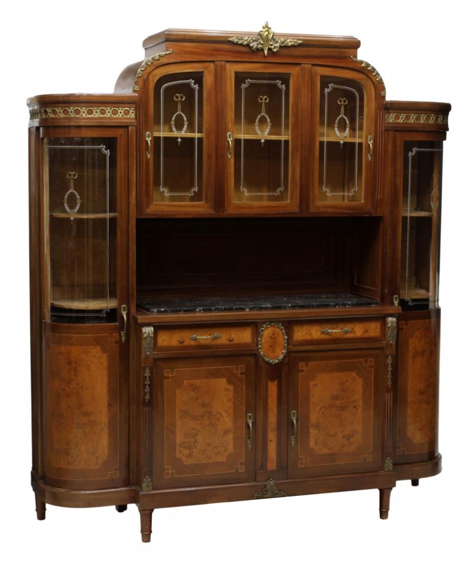 LARGE FRENCH CURVED GLASS DISPLAY SIDEBOARD: Large French walnut display sideboard, early 20th c., having a stepped cornice with centered gilt metal decoration, curved etched glass side doors flanking the three upper etched glass doors over the 
