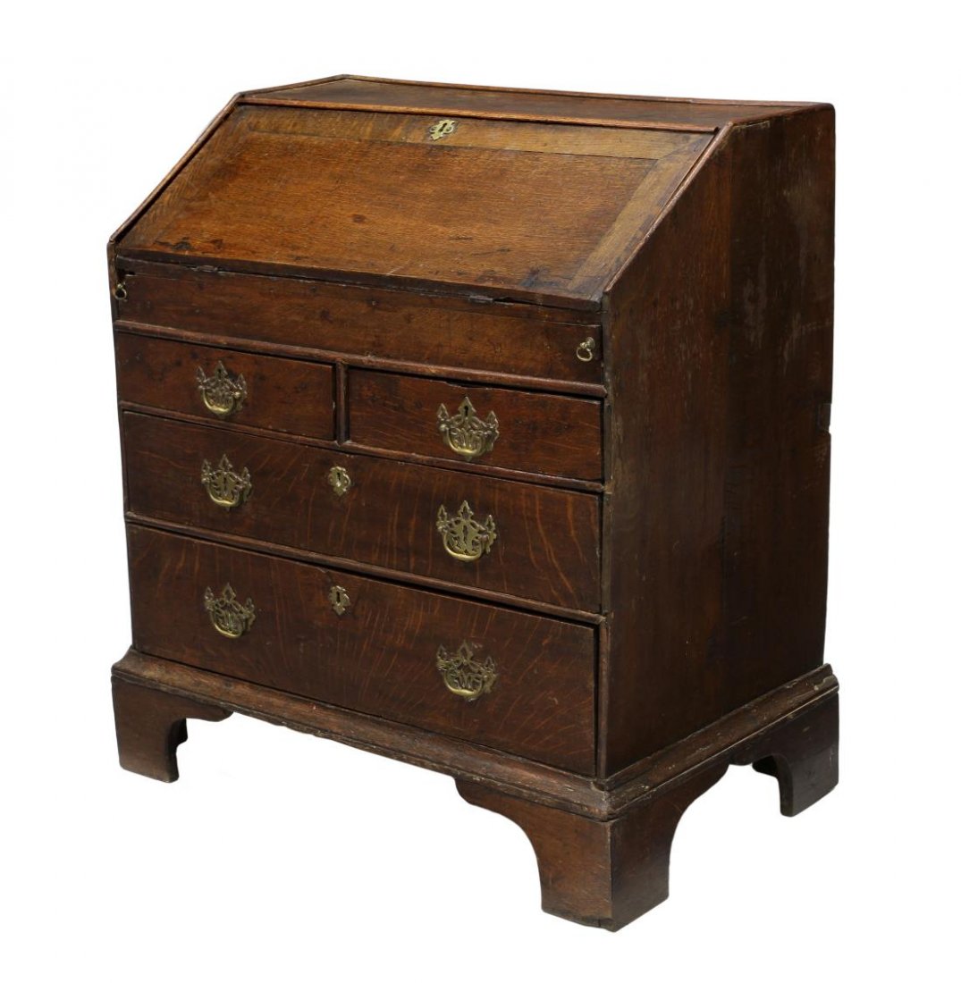 GEORGIAN OAK BUREAU SECRETARY: Georgian oak bureau, late 18th c. having a hinged slant front opening to a fitted gallery, sliding door storage, a leather writing surface with gilt accents, two short exterior drawers over two long d