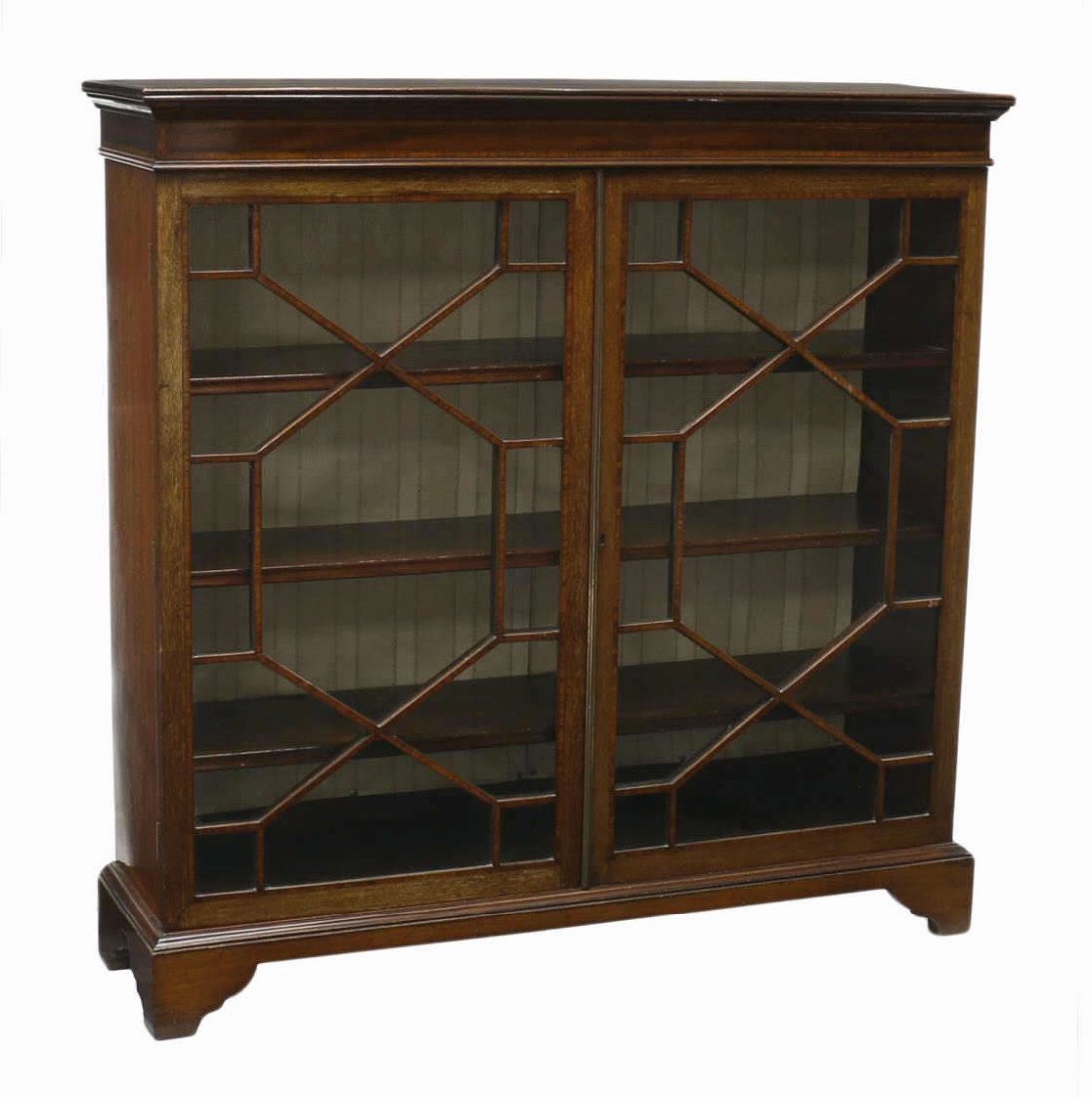 EDWARDIAN DOUBLE DOOR MAHOGANY BOOKCASE: Edwardian banded inlaid mahogany bookcase, early 20th c., having a stepped cornice over two multi-pane glass doors opening to adjustable height shelves, all rising on bracket feet, 48"h, 48"w, 13"d St