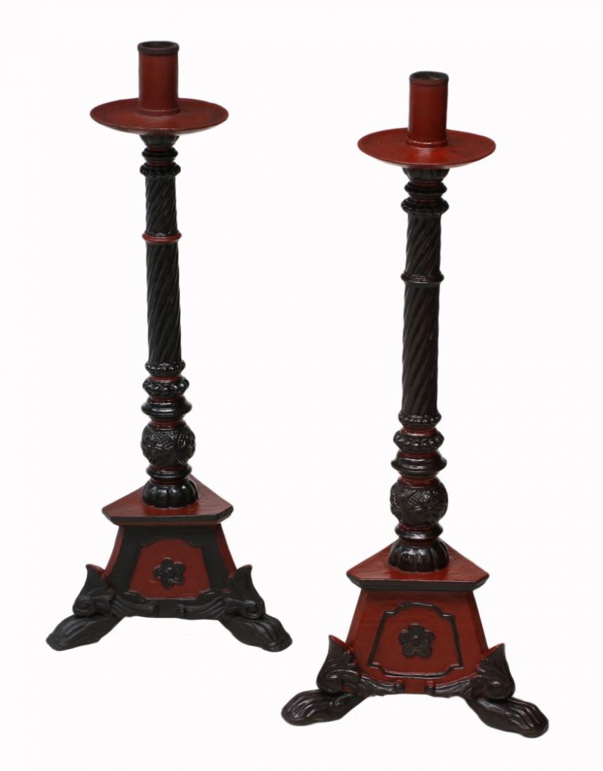 (PAIR) LARGE FRENCH COLONIAL ALTAR CANDLE HOLDERS: (pair) French Colonial altar candle holders in a red and black finish, early 20th c., a well carved standard rising on a paw foot tripartite base, slight differences to finish of each, largest: 37"h, 