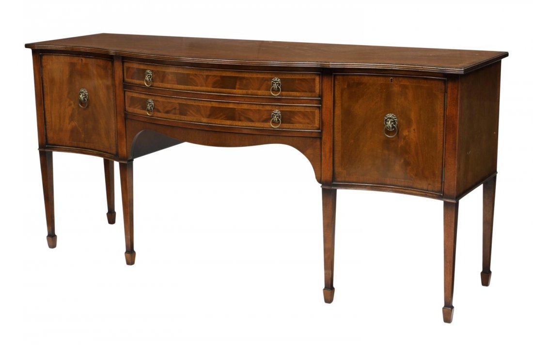 ENGLISH SHERATON STYLE MAHOGANY SIDEBOARD: English Sheraton style banded mahogany sideboard, the shaped top over a serpentine front with two central drawers flanked by a single door on each side, rising on tapered square leg with spade feet, 3