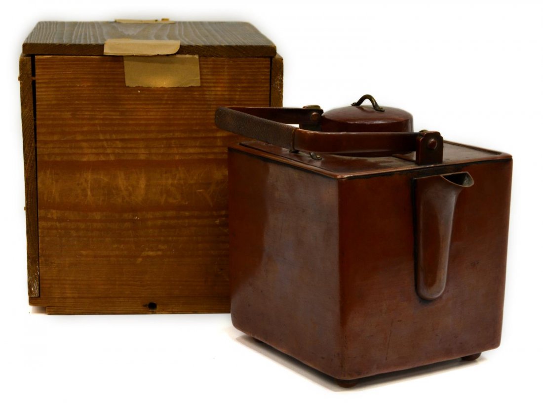 JAPANESE COPPER POURING KETTLE IN WOOD BOX: Japanese metal pouring vessel, square form with lid covers having handles and the interior with container for heating material, raised on a footed base and unmarked, accompanied by wooden box, 6.5"h, 