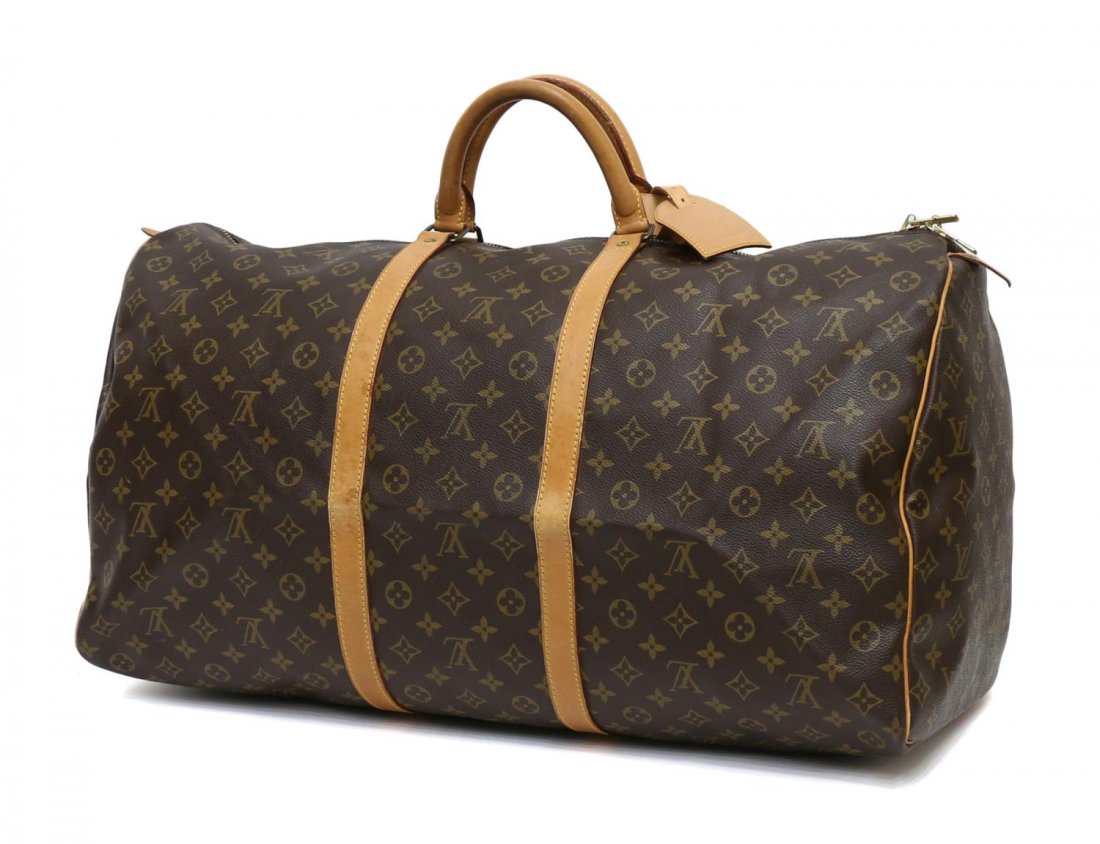 LOUIS VUITTON MONOGRAM KEEPALL 60 DUFFLE BAG: Louis Vuitton "Keepall 60" in monogram canvas traveling duffle bag, leather handles and trim, retaining luggage tag, stains to leather trim, patination, bag: approx 12"h, 24"l, 10"d, 1.75lbs Start Pri