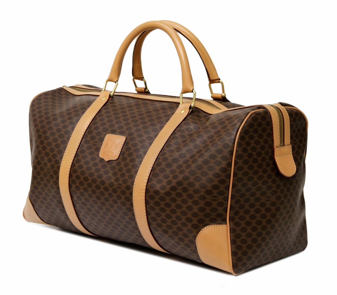 CELINE MONOGRAM CANVAS & LEATHER DUFFLE BAG: Celine monogram canvas duffle bag with leather trim and handles, interior pocket and handles Start Price: $125.00