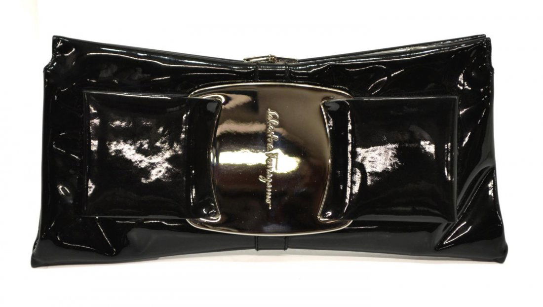 SALVATORE FERRAGAMO BLACK PATENT LEATHER CLUTCH: Salvatore Ferragamo clutch in black patent leather with silver tone hardware, beige suede interior with one side cell pocket, snap closure, accompanied by detachable long strap, wristlet strap and dus