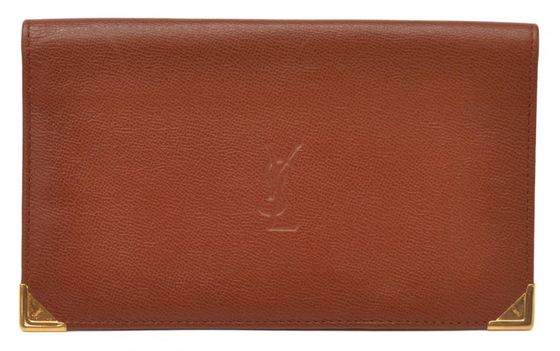 YVES SAINT-LAURENT LEATHER LONG WALLET: Yves Saint-Laurent long wallet/bill holder in cognac leather with gold tone hardware, interior card holders and bill compartments, YSL impression on front, wallet: approx. 4.25"h, 7"w Start Price: $40