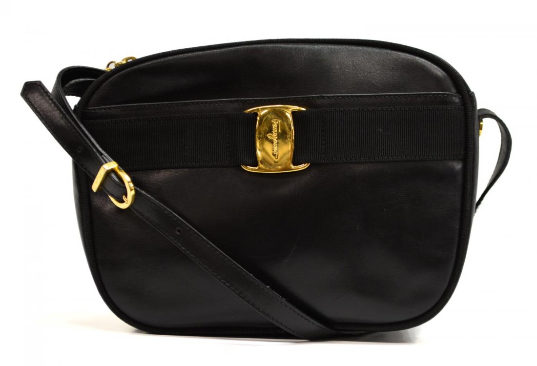 SALVATORE FERRAGAMO BLACK LEATHER CROSSBODY BAG: Salvatore Ferragamo shoulder cross body bag in black leather with gold tone hardware, single strap with gold buckle, black canvas trim and ribbon, black fabric interior with one side zipper pocket, zi