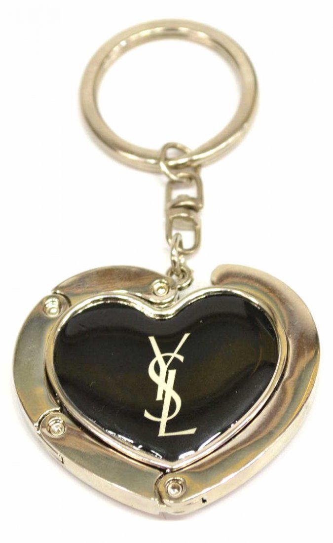 YVES SAINT LAURENT HEART FORM KEY CHAIN: Yves Saint Laurent key chain, silver tone hardware, black rubber heart with YSL logo, 3.5"l Start Price: $50.00