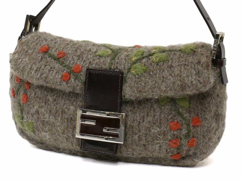 FENDI TAUPE KNITTED WOOL & FLORAL MOTIF HANDBAG: Fendi baguette in taupe knitted wool, brown leather strap and closure with silver tone metal snap clasp, the bag woven with orange leafy flowers, single zip pocket, orange satin liner with some discol