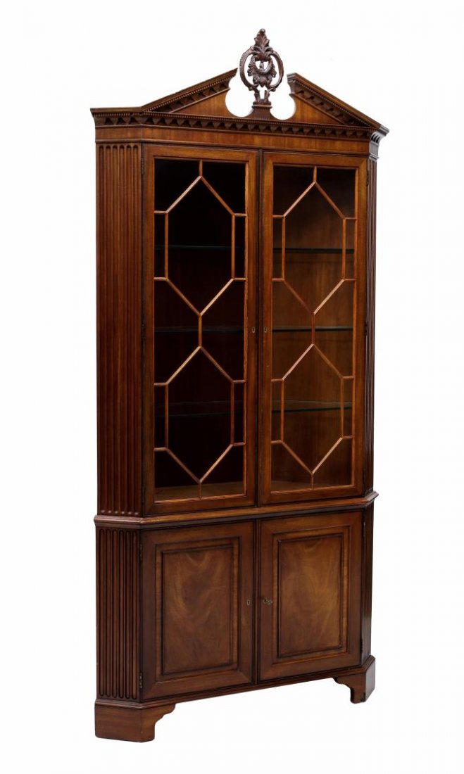HENREDON CORNER CABINET: Henredon corner cabinet having a foliate finial centered at the split pediment cornice over two astragal faced door opening to glass shelves, two paneled doors opening to shelves, all rising on bracke