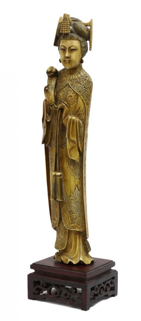 FINELY CARVED PATINATED QING IVORY EMPRESS, 12"H: *This item will not be shipped Internationally* Carved Chinese patinated ivory figure, late Qing dynasty, an Empress with coifed hair dressed in an elaborate gown holding a ruyi scepter, mounted on a 