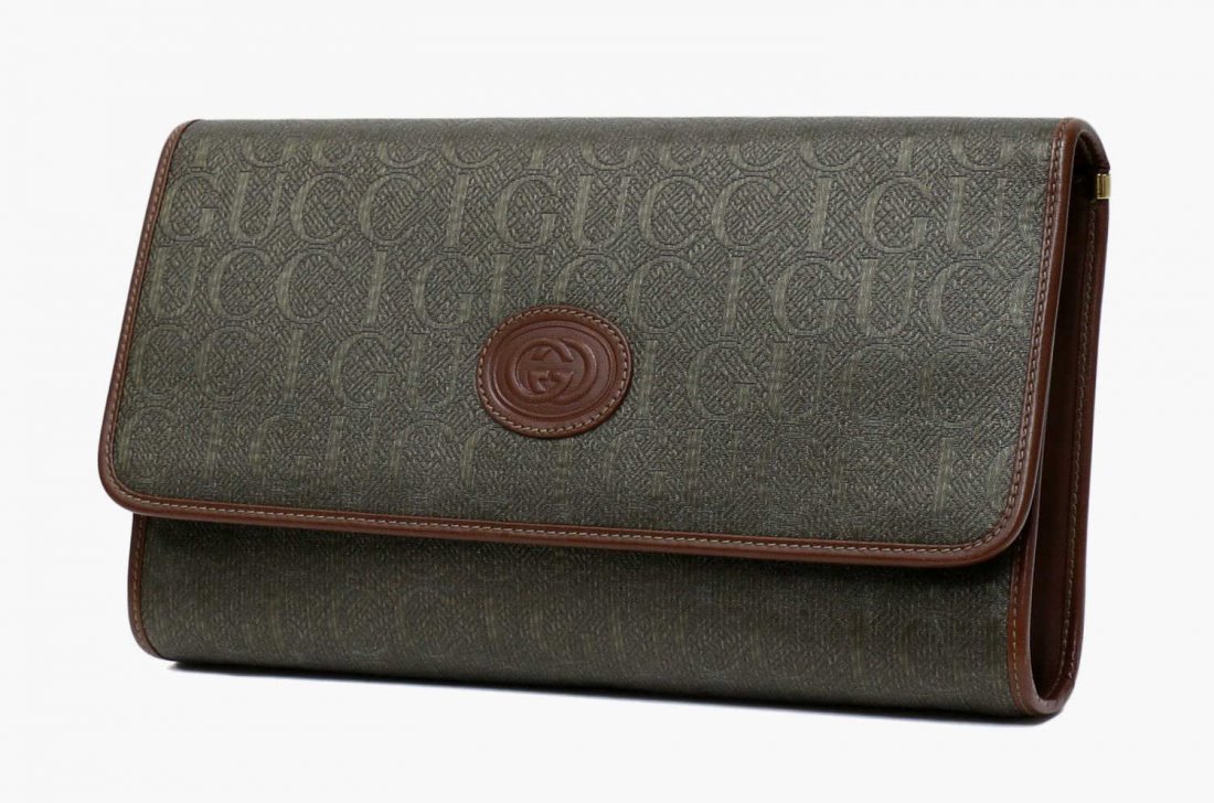 GUCCI GREEN COATED CANVAS MONOGRAM CLUTCH BAG: Gucci clutch purse in dark green coated canvas, brown leather trim, beige leather interior with one side zipper pocket, detachable long strap, accompanied by dust bag, bag: approx 7"h, 12"w, 2"d, 1lbs