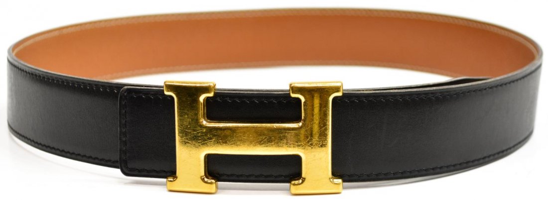 HERMES BLACK LEATHER 'H' GOLD TONE LOGO BELT: Hermes black leather belt, "H" gold tone buckle, brown interior marked and stamped square D, 1T7, surface scratches to buckle, size 70, .25lbs Start Price: $175.00