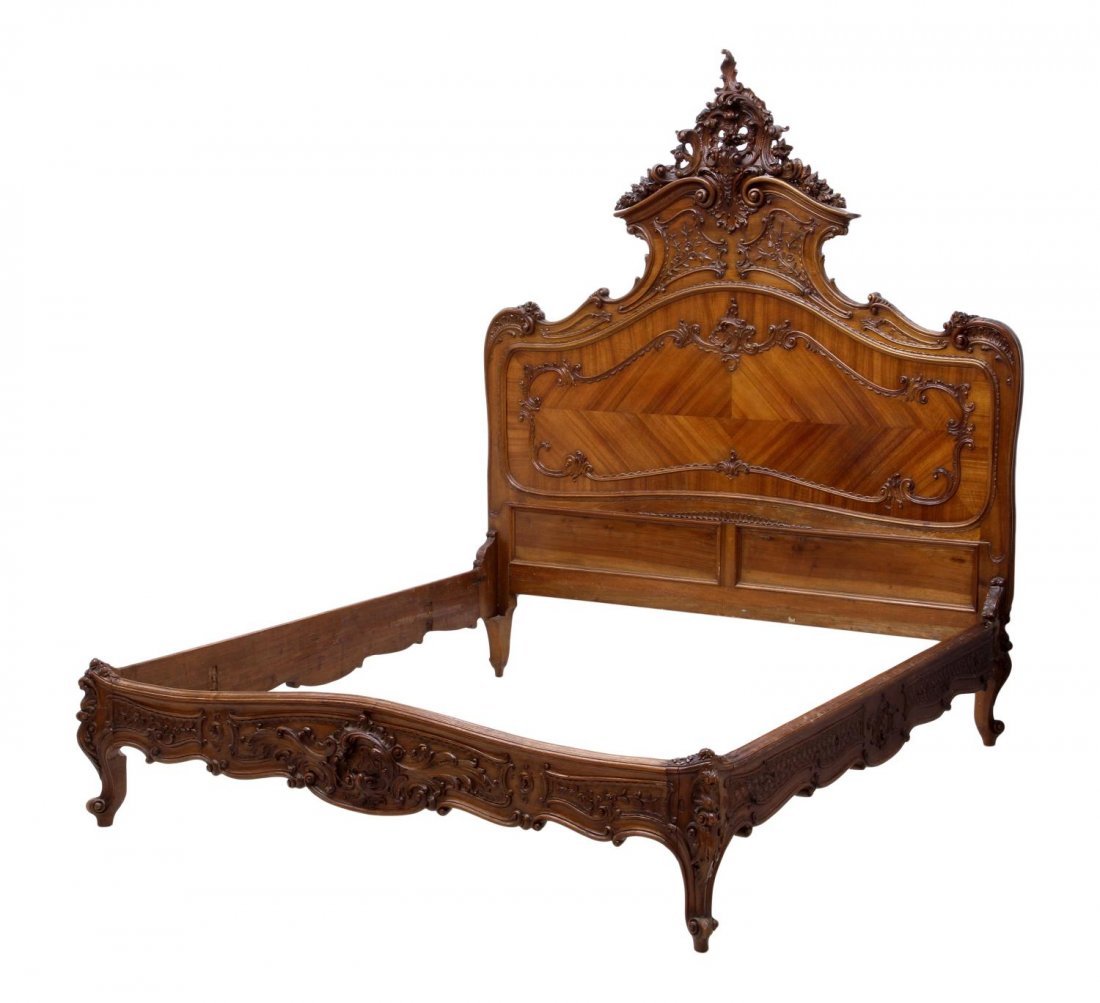 ITALIAN LOUIS XV STYLE BED: Italian Louis XV style bed, c. 1900, having a substantial pierced carved shell and foliate crest over the shaped headboard further accented with applied foliate carving, the low footboard rising on sc
