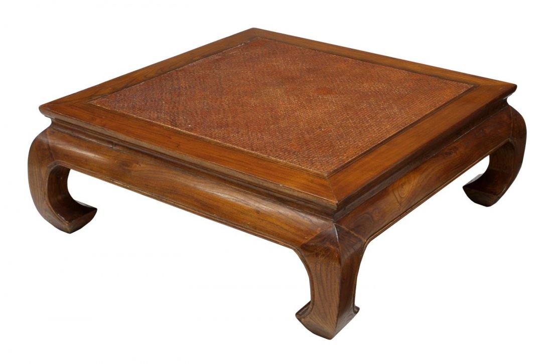 CHINESE ELMWOOD & RATTAN COFFEE TABLE: Chinese elmwood coffee table, 20th c., having an inset rattan top, rising on inward curved legs, 15.5"h, 42"w, 42"d Start Price: $100.00