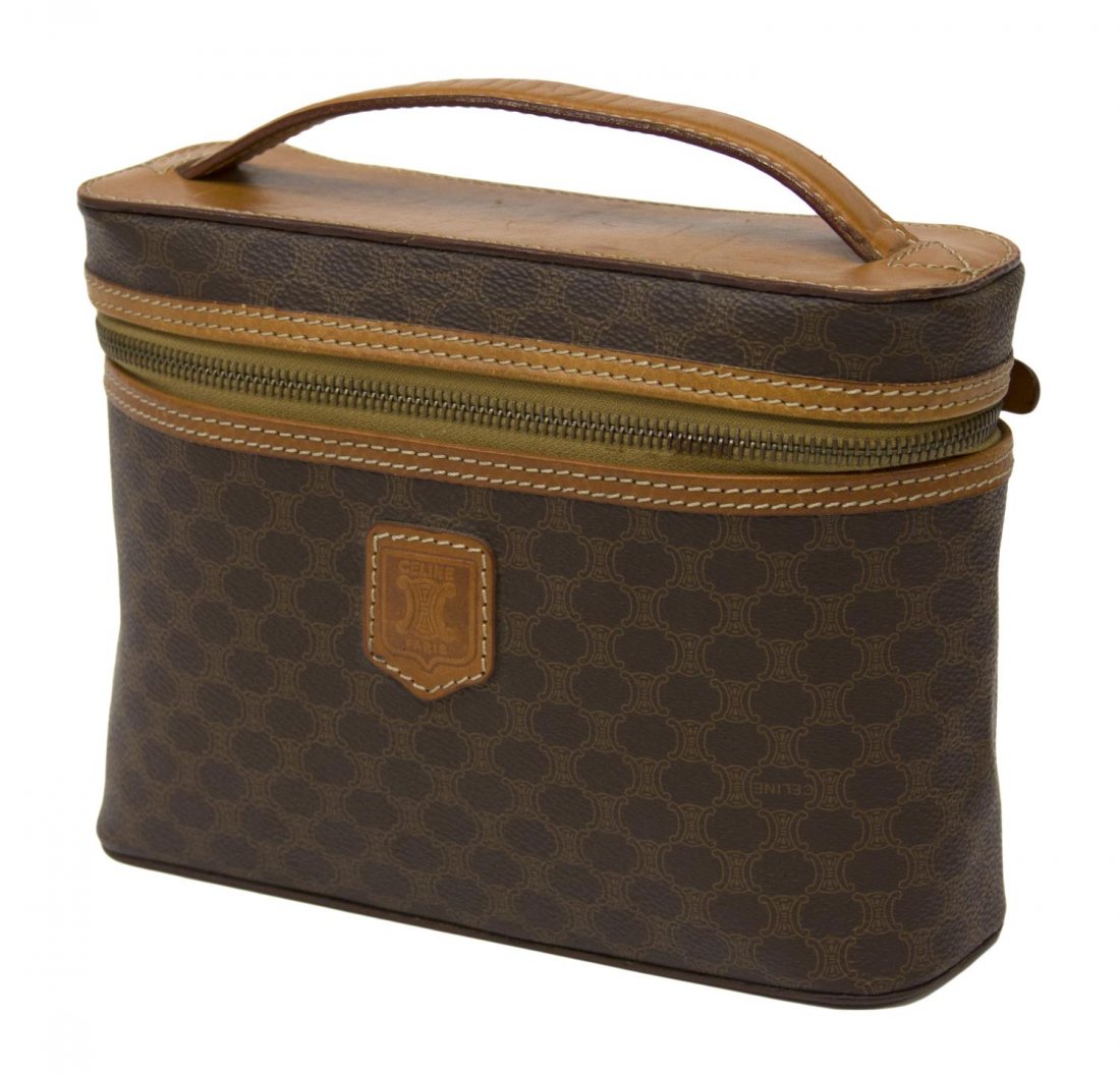 CELINE MONOGRAM CANVAS COSMETIC BAG: Celine cosmetic bag in brown monogram canvas, single leather handle, light brown interior, minor wear to the exterior, bag: approx 6"h, 8.75"w, 2.75"d, .75lbs Start Price: $40.00