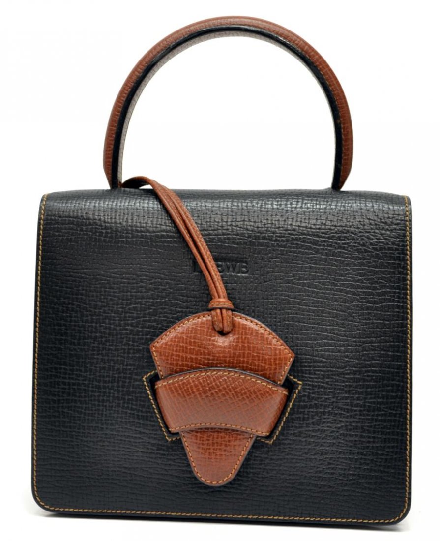 LOWE SPAIN GRAINED BLACK & BROWN LEATHER HANDBAG: Lowe handbag in black grained leather with brown handle, light suede interior with zipped and slot pockets, several spots to interior, bag: approx 7.75"h, 8.75"w, .75lb Start Price: $80.00