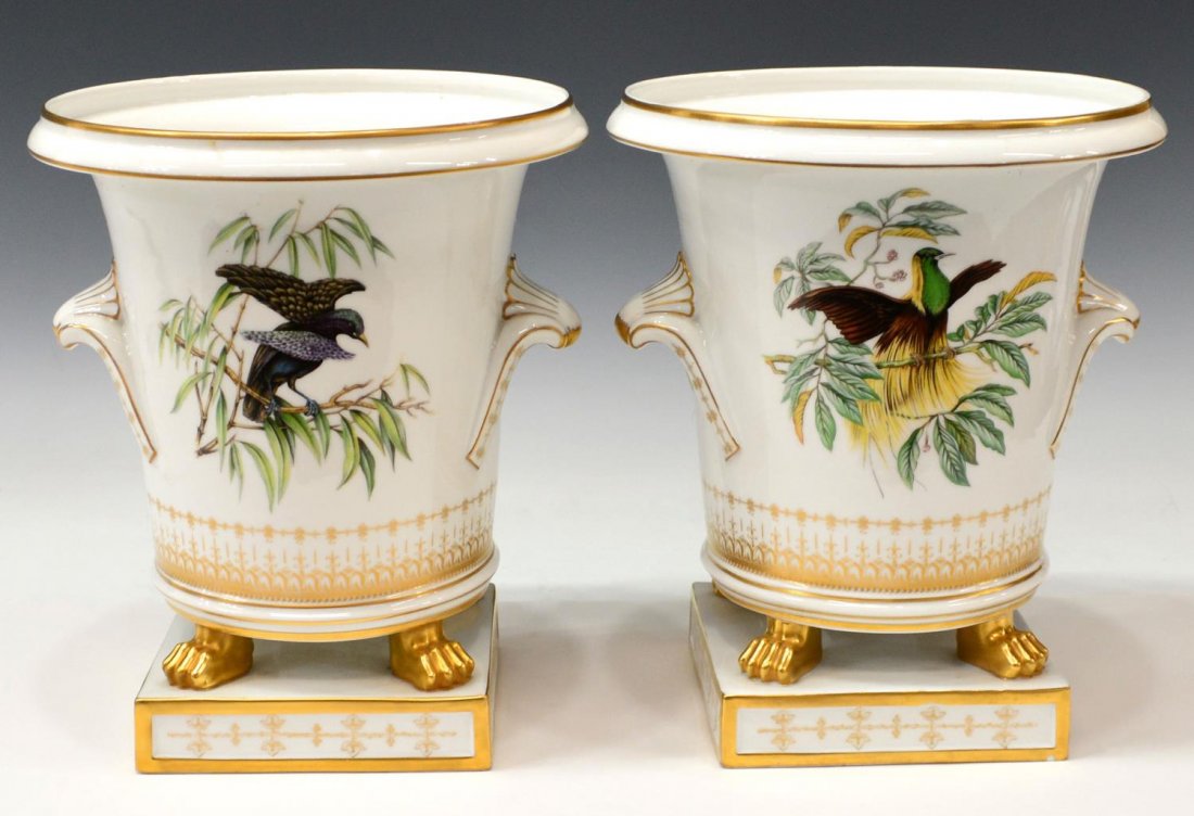 (2) MOTTAHEDEH GILDED BIRDS OF PARADISE CACHEPOTS: (pair) Large Mottahedeh Bird of Paradise porcelain cachepots, each with ornate parcel gilt decor on the handled pot painted with birds, rising on brightly gilded paw feet, on a square base: (1) decora