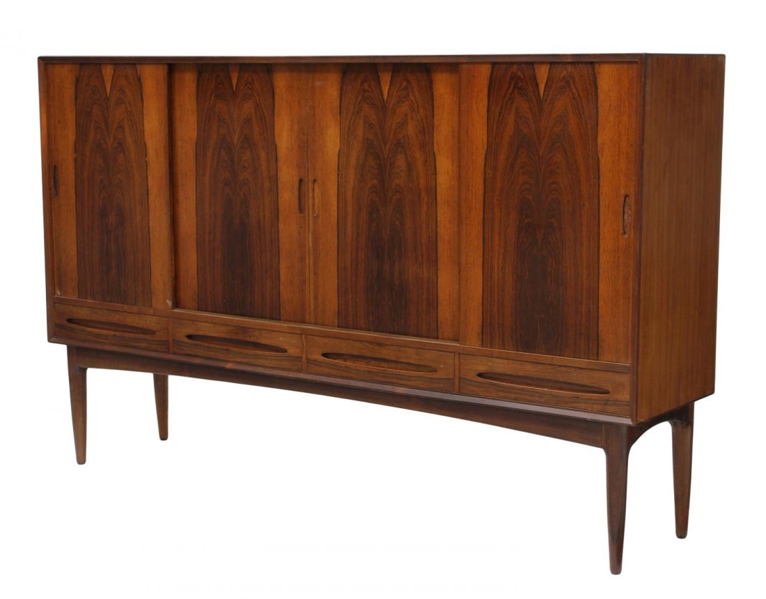 DANISH MID-CENTURY MODERN SIDEBOARD: Danish mid-century modern rosewood and teakwood sideboard, c. 1960, four doors opening to shelves, four lower drawers, rising on turned tapered legs, 47.25"h, 75"l, 17.25"d Start Price: $600.00