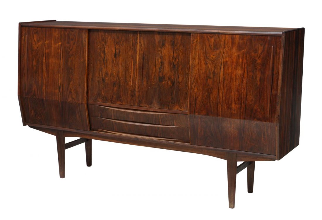 DANISH MID-CENTURY MODERN ROSEWOOD SIDEBOARD: Danish mid-century modern rosewood sideboard, 1960's, the slant front with sliding doors opening to shelves and a central mirrored bar with drawers, two lower doors, rising on tapered legs, 45"h, 79"l