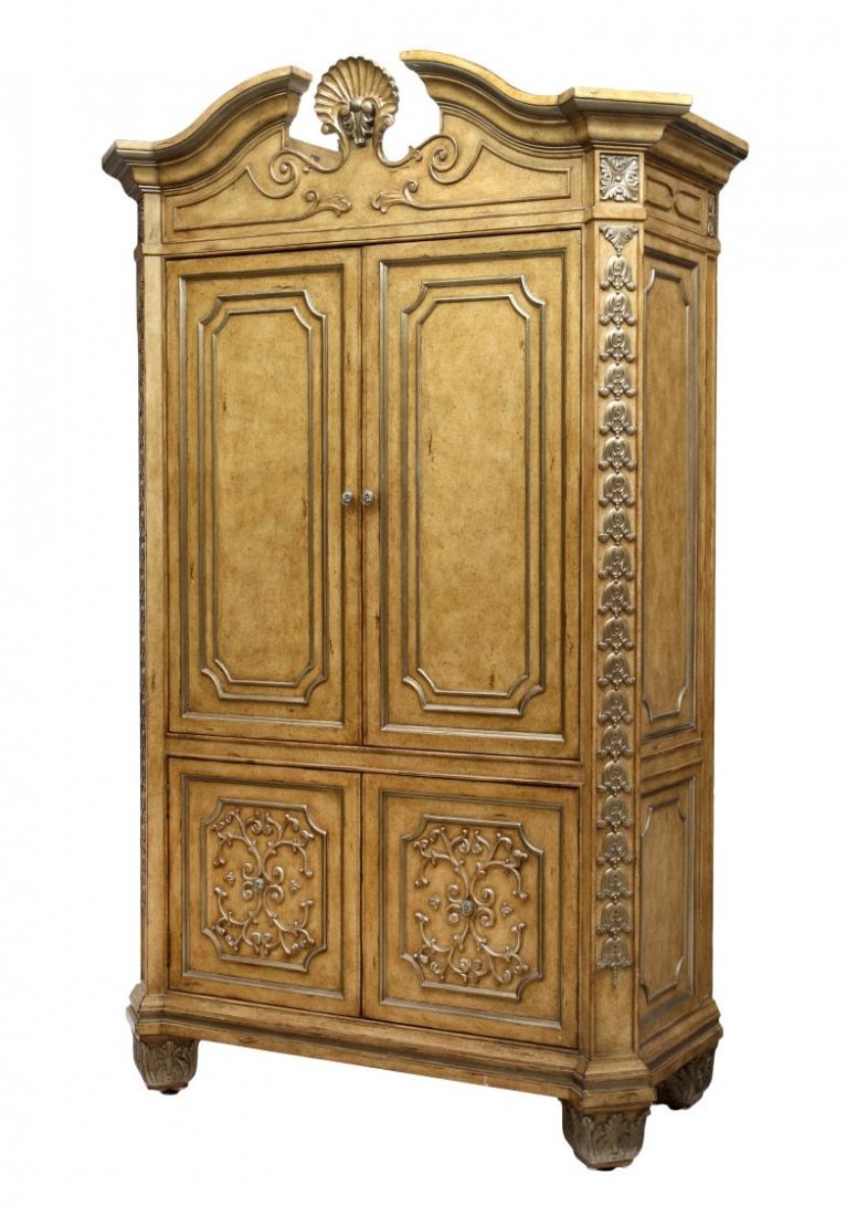 LARGE MARGE CARSON ENTERTAINMENT CABINET: Large entertainment cabinet by Marge Carson Inc. with silvered foliate accents, a split pediment top with central finial over two slide in doors opening to a television stand, two lower doors opening