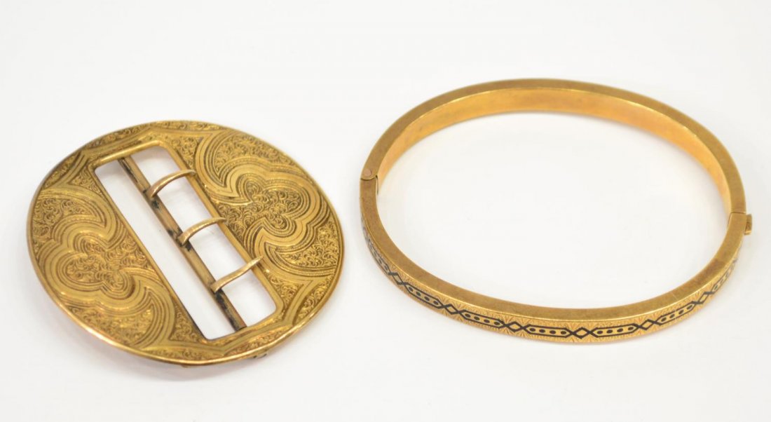 (2) VICTORIAN GOLD JEWERLY, BUCKLE & BRACELET: (lot of 2) Victorian gold jewelry group: (1) 16kt gold engraved buckle brooch of circular form, 1.75"diam, 13.4 grams; (1) engraved child's bangle with black accents, lacking safety chain, testing as 