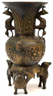 CHINESE BRONZE ARCHAIC MOTIF WINGED BIRD VASE: Chinese bronze vase, raised archaic detail on the bulbous vase having a pair of birds flanked to either side of the flared rim, the whole sported on a base fashioned with three birds, 13.25"h, 6.5"d,