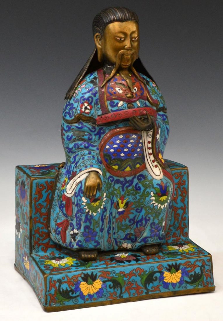 LARGE CHINESE CLOISONNE ENAMEL SEATED FIGURE: Chinese cloisonne enamel figure of an elder in long robe seated upon a raised throne, decorated with lotus and scrolling vines on a turquoise field, 15.25"h, 10"w, 6.25"d, 5.75lbs Start Price: $200.00