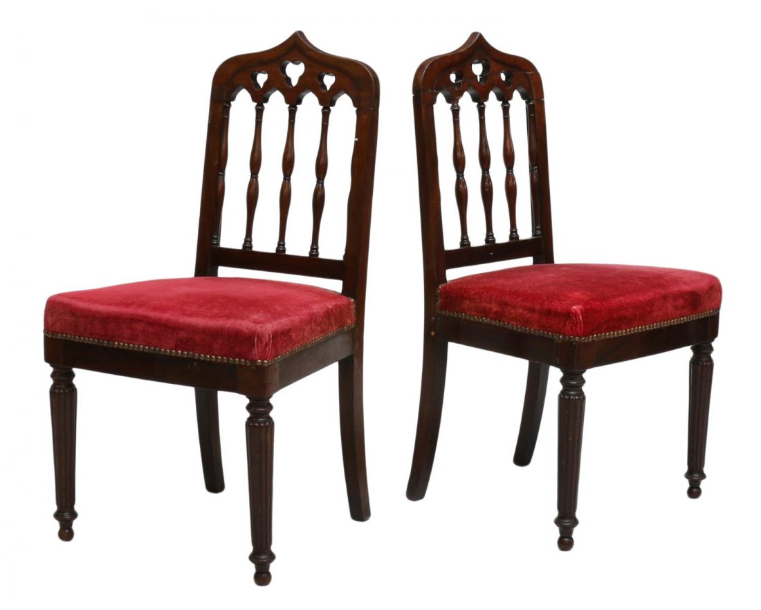 (2) GOTHIC STYLE MAHOGANY SIDE CHAIRS: (lot of 2) Gothic style mahogany side chairs, c. 1900, having a shaped crest rail over trefoil cutouts, spindle supports, a red fabric seat, rising on front ribbed legs with blunt arrow feet, one with