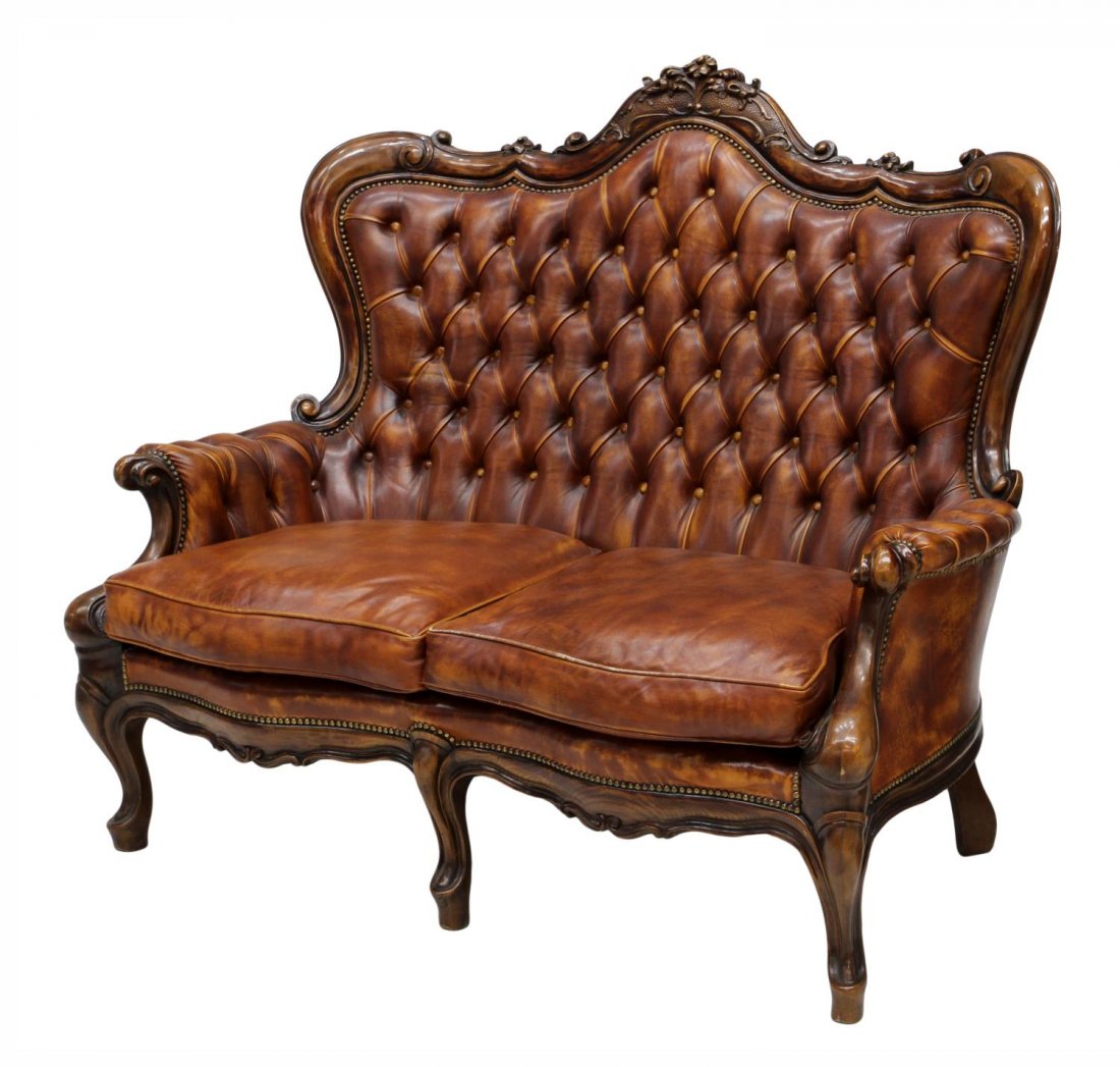 ITALIAN LOUIS XV STYLE BUTTONED LEATHER SETTEE: Italian Louis XV style club settee, 20th c., a floral carved crest rail over the buttoned back and arms framing the two removable seat cushions, rising on cabriole legs, 44"h, 52"l, 27.5"d Start Price