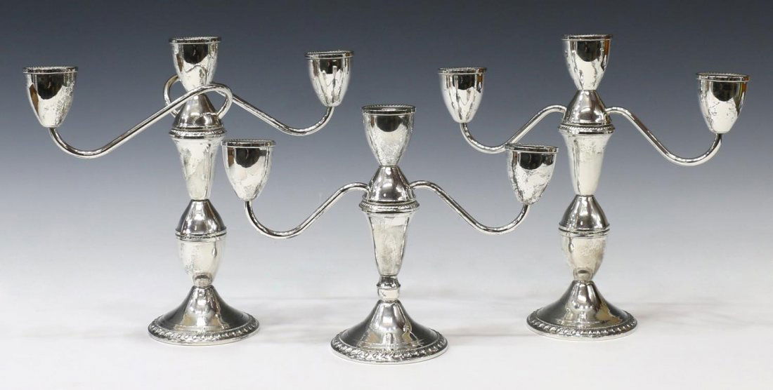 (3) DUCHIN SILVERPLATE THREE-LIGHT CANDELABRA: (set of 3) Duchin silver plate convertible candelabra, weighted, each having three lights on a scrolled branch, assembled in three pieces and rising on a pedestal foot with gadrooned rim, (2) larger,