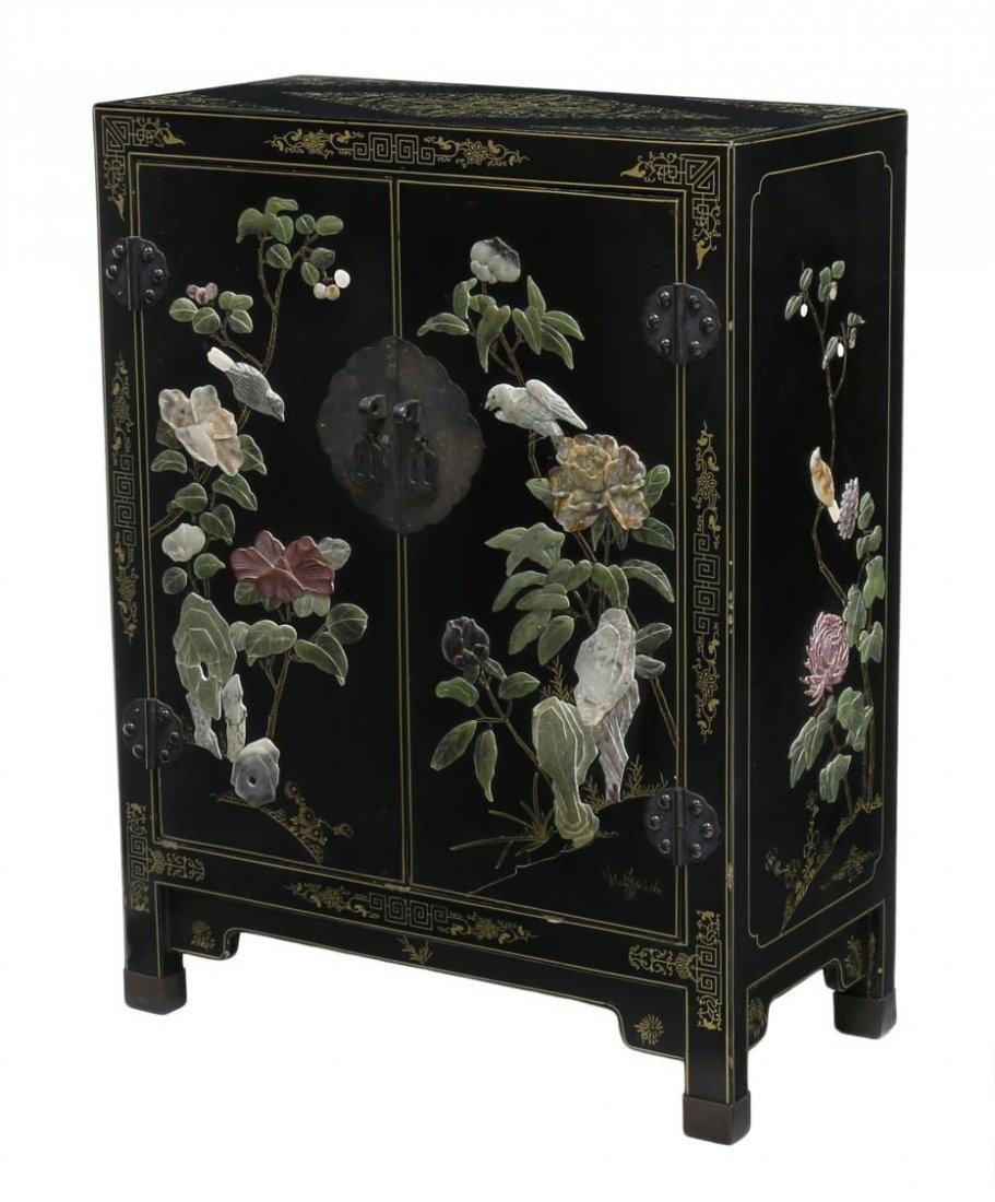 CHINESE BLACK LACQUERED STONE DECORATED CABINET: Diminutive parcel gilt Chinese black lacquered cabinet, 20th c., having two doors decorated with raised multi-color stones formed as birds and foliage, set on short squared legs, 30"h, 23"w, 11"d Star