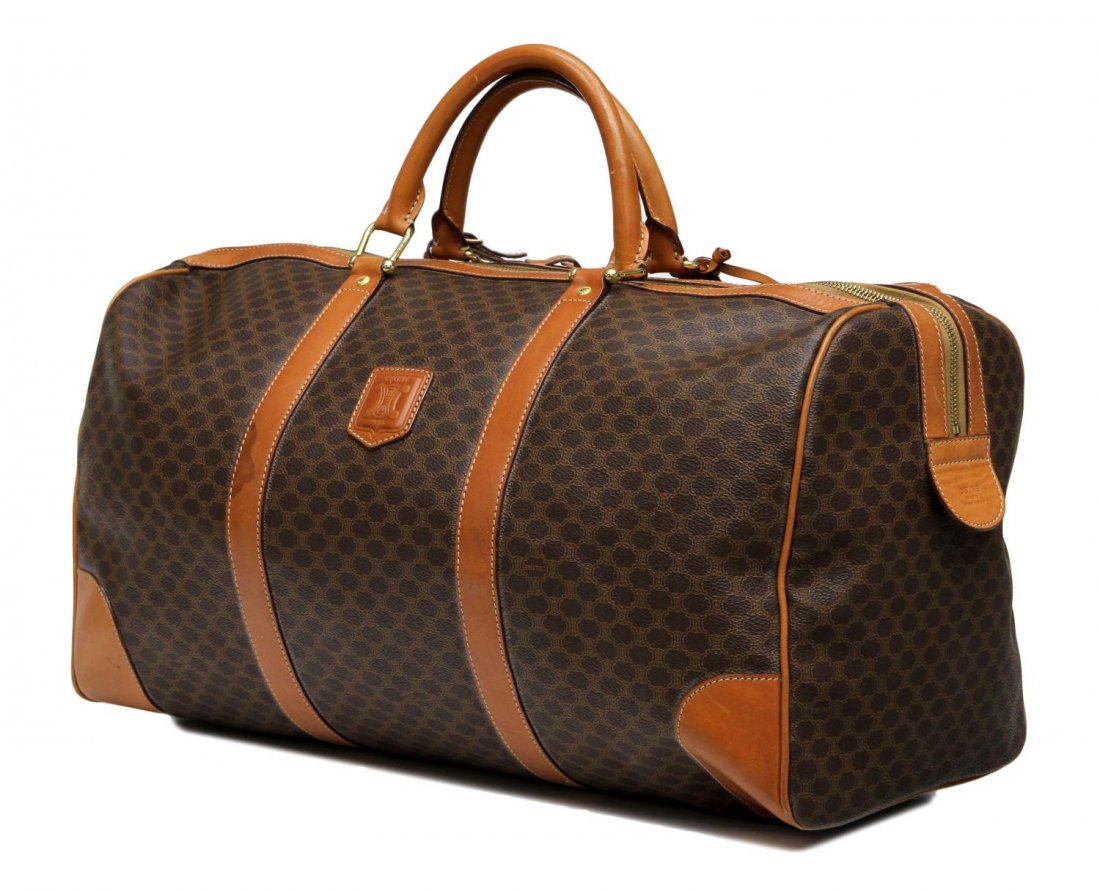 CELINE BROWN MACADAM CANVAS TRAVEL BAG: Vintage Celine Paris travel bag in brown macadam monogrammed canvas, tan leather handles, gold tone hardware, single zip opening to brown interior with single zip pocket, accompanied by luggage tag, l