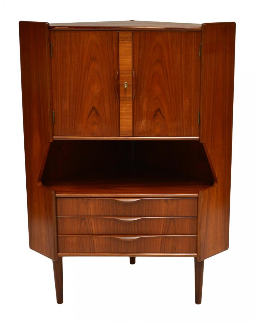 DANISH MID-CENTURY MODERN TEAKWOOD CORNER BAR: Danish mid-century modern teakwood corner cabinet bar, the upper section with a pair of cabinet doors opening to a mirrored and shelved interior, lower section under recess with three drawers, the who
