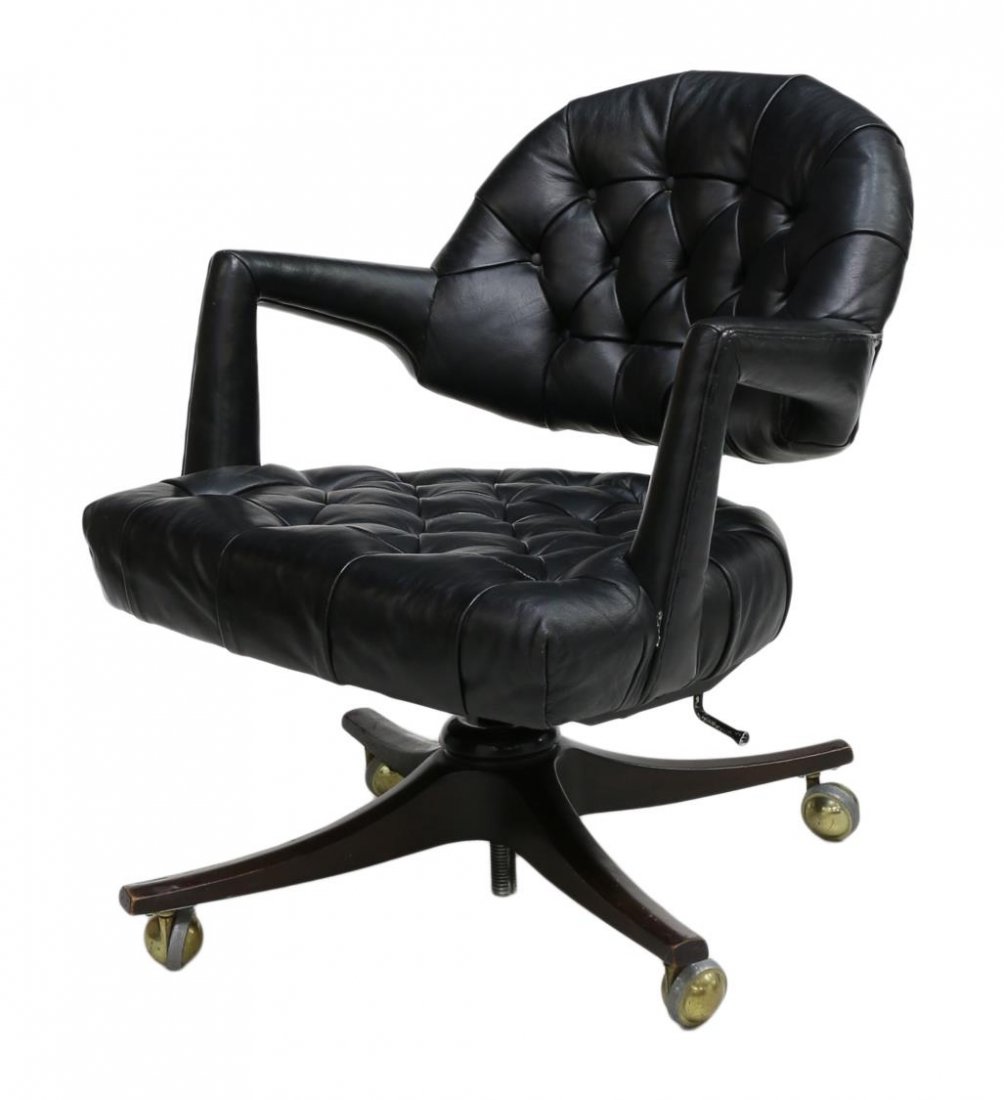 SCARCE WORMLEY SWIVEL OFFICE CHAIR, MODEL 931: Dunbar "Executive" swivel office chair, Model 971, design by Edward Wormley (American, 1907-1995), upholstered in black buttoned leather, an arched back open above the seat, outward curving arms, risi