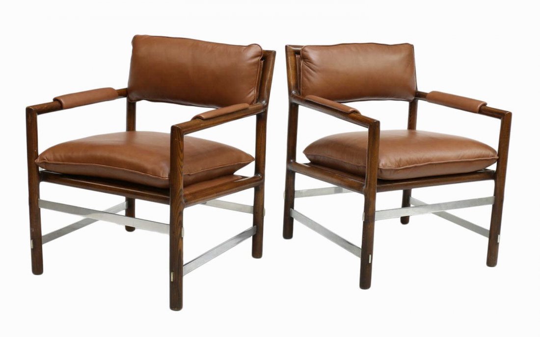 (2) WORMLEY DUNBAR LEATHER ARM CHAIRS: (lot of 2) Dunbar arm chairs, design by Edward Wormley (American, 1907-1995), slanted brown leather cushioned back with turned padded arms, a brown leather cushioned seat, four aluminum stretchers mor