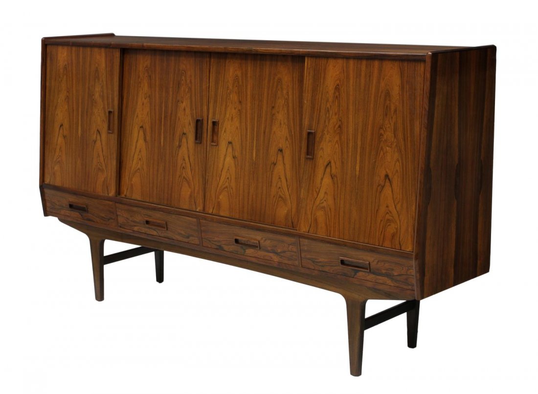 DANISH MID-CENTURY MODERN ROSEWOOD SIDEBOARD: Danish mid-century modern rosewood sideboard, the slant front with four sliding doors opening to shelves and a central mirrored bar over a column of three drawers, over a row of four short drawers, ri