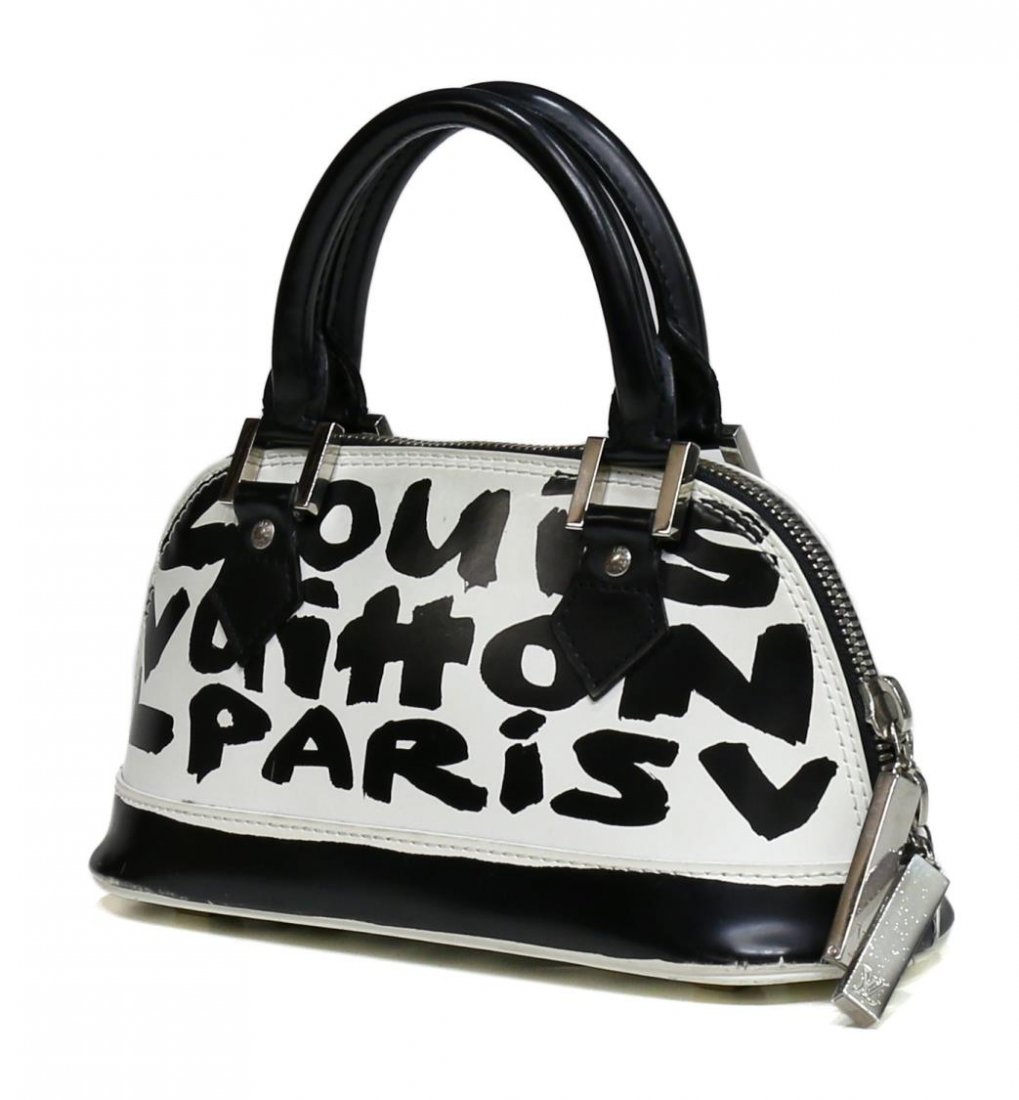 LOUIS VUITTON ALMA GRAFFITI BLACK WHITE PURSE: Louis Vuitton 'Alma' in Graffiti black and white matte leather with silver tone hardware, limited edition design by Stephen Sprouse, two rolled handles, black fabric interior with one cell pocket, bag