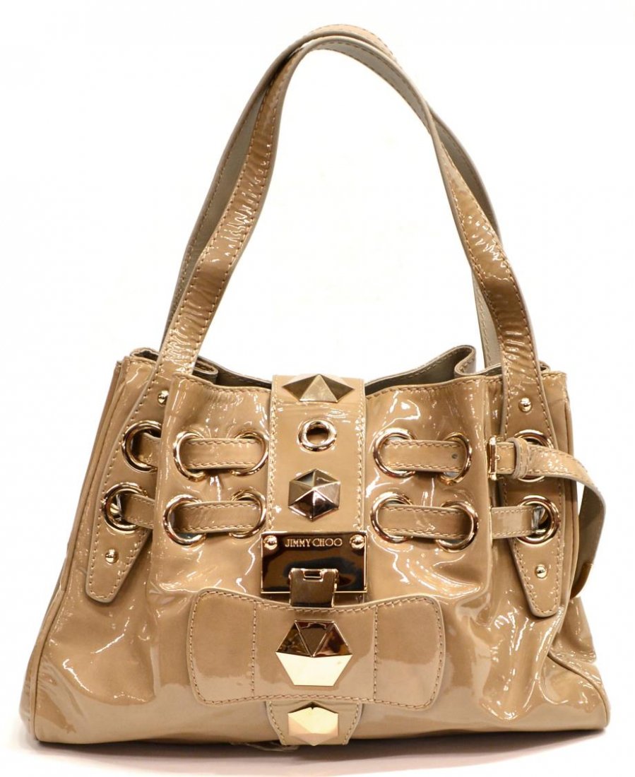JIMMY CHOO "RIKI" PATENT LEATHER TOTE BAG: Jimmy Choo "Riki" patent leather tote in beige, silver tone hardware and studs, front flip lock clasp opening to mustard lined interior with three wall pockets and single zip pocket, accompanied by du
