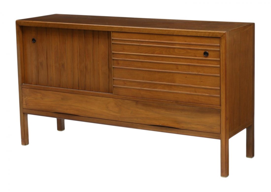 WORMLEY DUNBAR SLIDING DOOR SIDEBOARD: Dunbar sideboard cabinet, design by Edward Wormley (American, 1907-1995), rectangular with two sliding doors opening to shelved storage and a single silver drawer, a lower long drawer, Dunbar tag in s