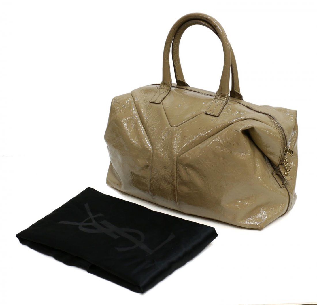 YVES SAINT LAURENT BEIGE PATENT LEATHER HANDBAG: Yves Saint Laurent handbag in beige patent leather with embossed monogram, dark olive interior with one side zipper pocket and two open cells, single zipper closure, some marks to exterior, accompanie